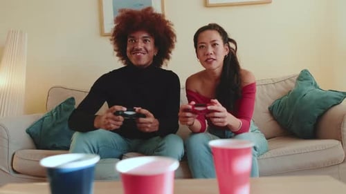 Young Couple Playing Video Games on Couch