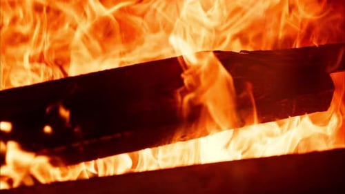 Close up of wood burning with a strong flame in a fireplace