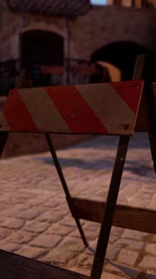 A Red and White Sign Sitting on the Side of a Road