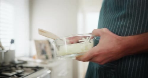 Man Cooking with Sliced Onions in Home Kitchen
