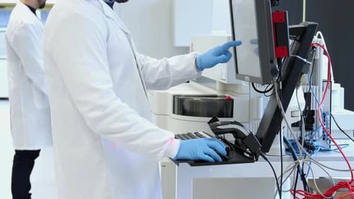 Scientist operating laboratory equipment analyzes data