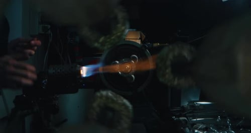 Slow motion close up of experienced glass blower working on a handmade wine glass from crystal in