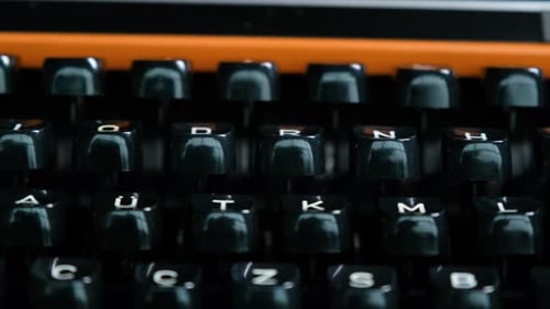 Writing letters with orange retro vintage typewriter