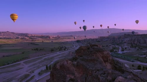 Hot Air Balloons Flying Over a Desert Landscape