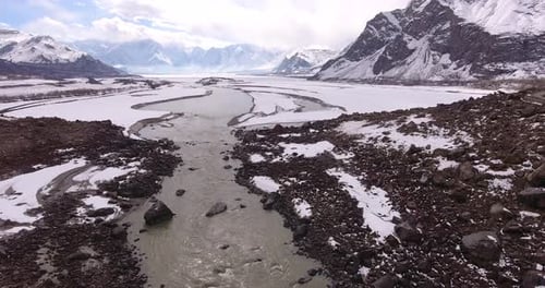Aerial view of snow-covered mountains and river in winter, Pakistan.