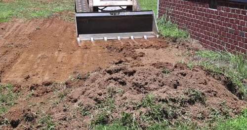 Loader Prepares Ground in Rural Setting