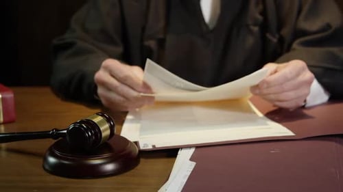 Judge closes up folder and hammers his gavel to end court case HD