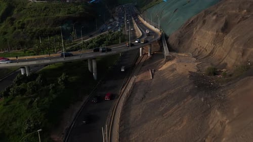 Aerial Drone View of Costa Verde Highway Traffic in Lima Peru Showing Cliffside Cityscape and Puente