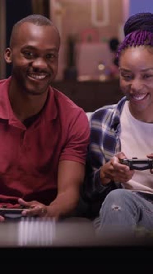 Couple Laughing and Playing Video Games Together