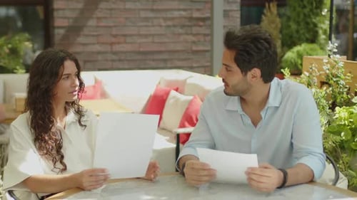 A woman and a man are having a conversation in a summer cafe