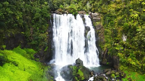 Drone pull away shot of a waterfall at high rocky cliff. 4K videos.