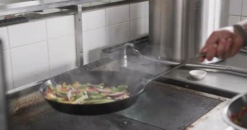 Chef Cooking Vegetables in Commercial Kitchen