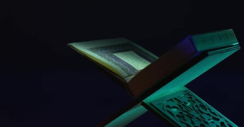 Ornate Religious Book Opening on Carved Stand