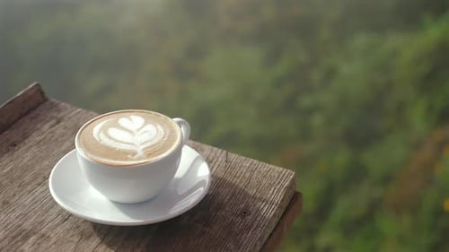 Latte Art Coffee Cup on Tropical Mountain Balcony