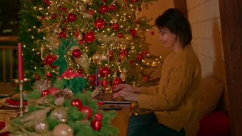 Side View Brunette Working on Computer Winter Holidays