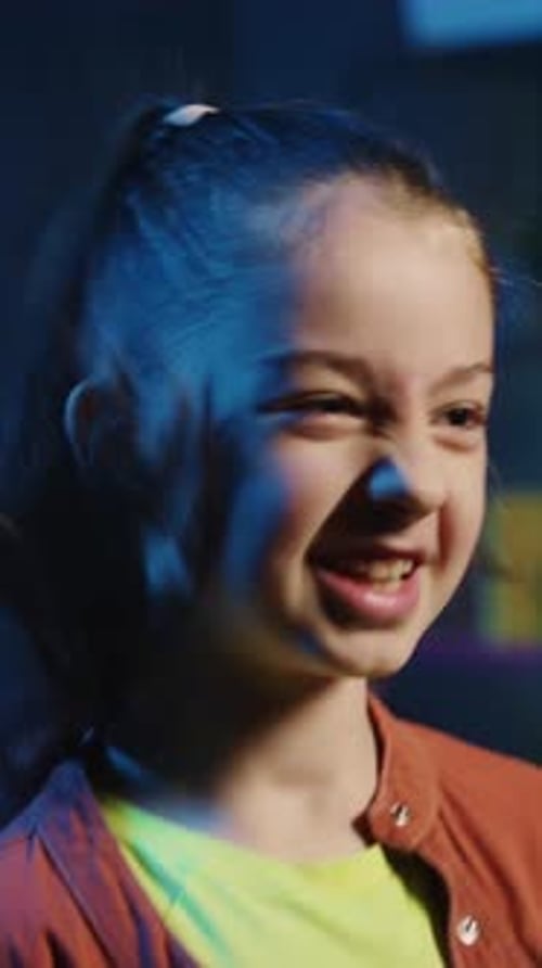 Happy Child Smiling and Talking Indoors at Night