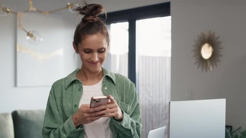 Woman Using Smartphone Happily Indoors