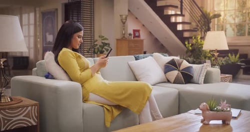 Woman Relaxing at Home Using Her Phone