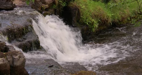 Shot of a small waterfall Entering the river swale, at keld, Swaledale