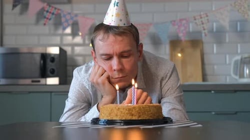 Lonely Man Blows Out Birthday Cake Candles