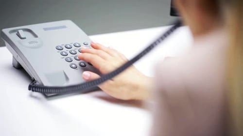Woman Dialing Phone in Modern Office