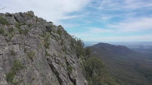 Aerial: Eroded steep hard rock of Sugarloaf mountain in Victoria, AUS