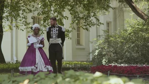 Aristocratic Couple Walking in Garden on Summer Day