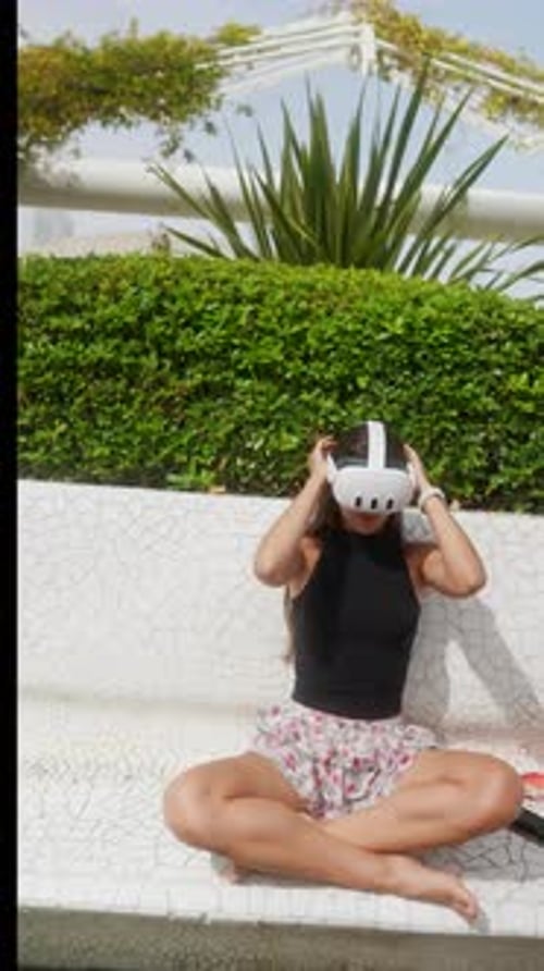 Woman Uses VR Headset in Urban Park