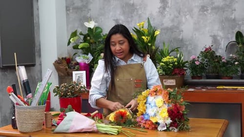Woman Arranging Flowers in a Flower Shop