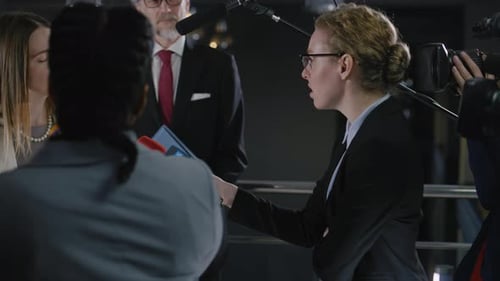 Woman Giving Press Interview in Urban Setting