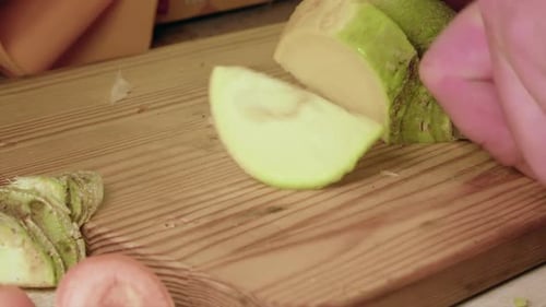 Food prep: Raw turnip vegetable is sliced into pieces, close up view