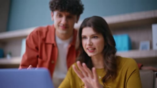 Young Adults Collaborating on Computer in Office
