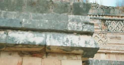 Close-up of weathered stone detail on an ancient Mayan ruins wall in Yucatan Mexico