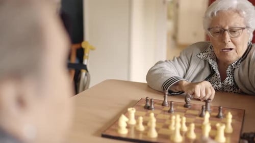 Senior Friends Playing Chess in a Nursing Home