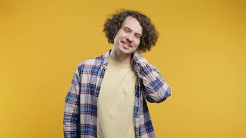Man Rubbing His Neck in Discomfort