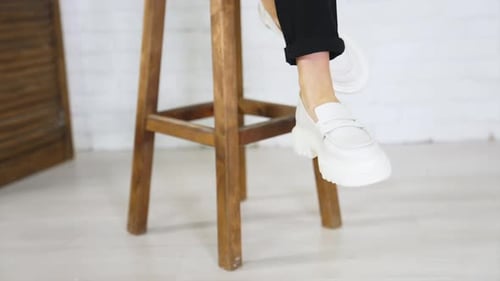 Presentation of white shoes with plain massive soles.