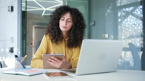 Professional Woman Working at Laptop in Modern Office