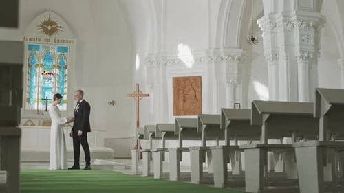 Newlywed Couple Cuddling in Church on Wedding Day