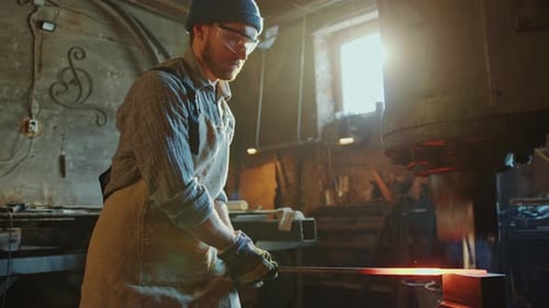 Blacksmith Forging Iron Rod with Hydraulic Press Machine in Workshop