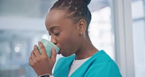 Medical nurse, drinking coffee and a smile on face on a break in a hospital for health care