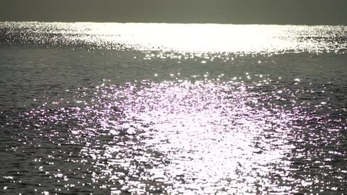 Abstract Shining Sun Reflections on Blue Surface of Sea Waves Bokeh Sun Glare Reflected in Water