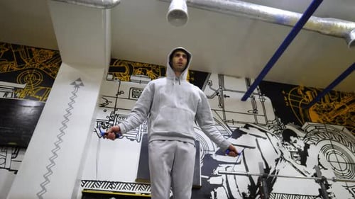 Young Sportsman Skipping with a Jump Rope at Modern Gym Strong Sporty Man Exercising in Fitness
