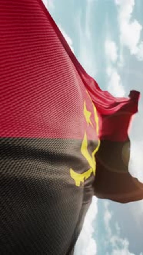 Angola Flag Waving in Slow Motion on Cloudy Sky Background