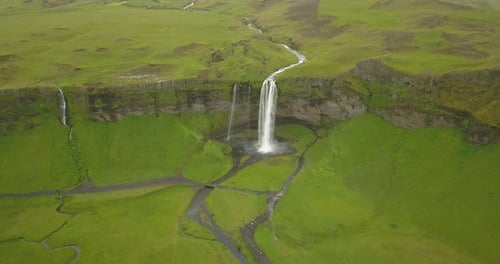 Aerial view of Large waterfall with green landscape in Iceland