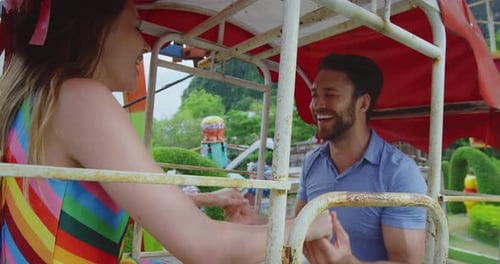 Young Happy Couple on Amusement Park Ride, Thailand Asia Carnival Ride