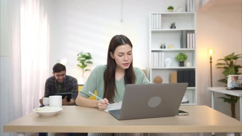 Young Woman Studying at Home with Laptop