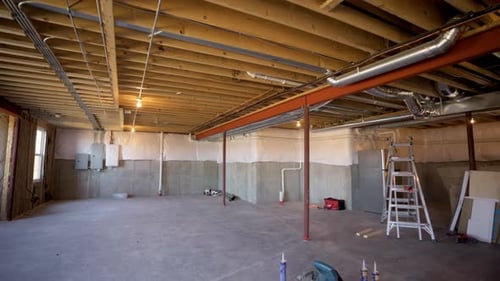 Unfinished Basement with Visible Wood Beams and Concrete