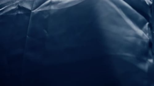 Wrinkled Blue Textile Shimmers with Glittery Light