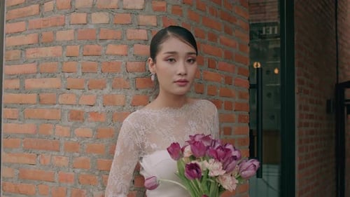Portrait of Charming Thai Bride in Lace Wedding Dress Posing on the Street Holding Wedding Bouquet