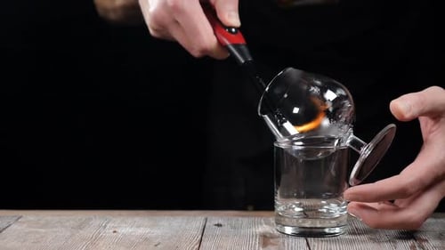 Preparing Cocktail with Fire in a Bar Setting